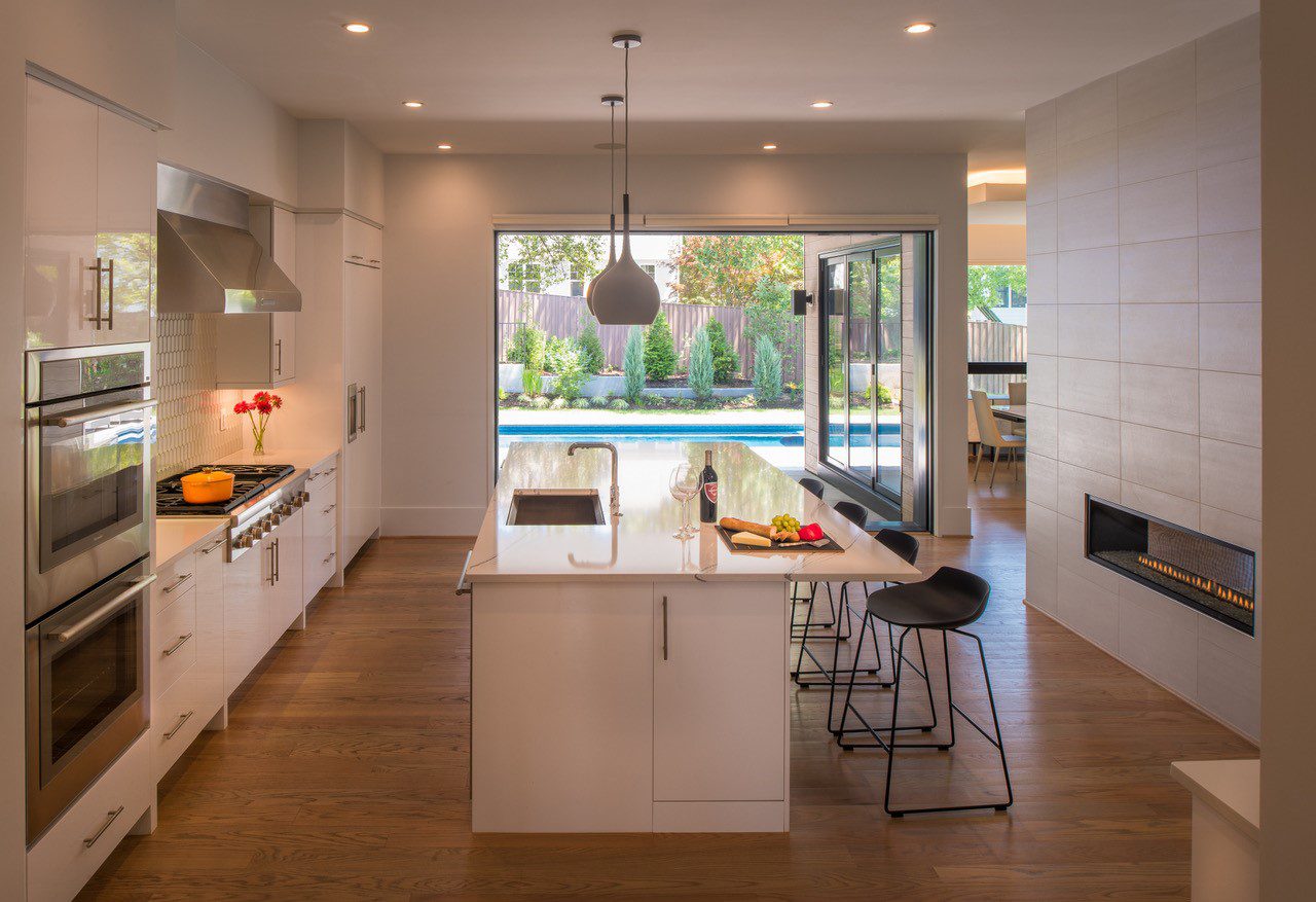 White Kitchen with Large Folding Windows and Doors Modern Style Custom Home with Solar Panels by AV Architects and Builders in Arlington Northern Virginia